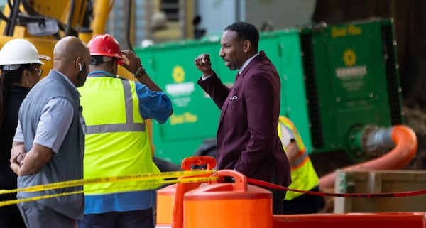 Atlanta Mayor Andre Dickens (right) on Tuesday morning, June 4, 2024 visited West Peachtree Street and 11th Street in Midtown, where repairs are ongoing to fix a broken main on the fifth day of the water crisis. (John Spink/AJC)