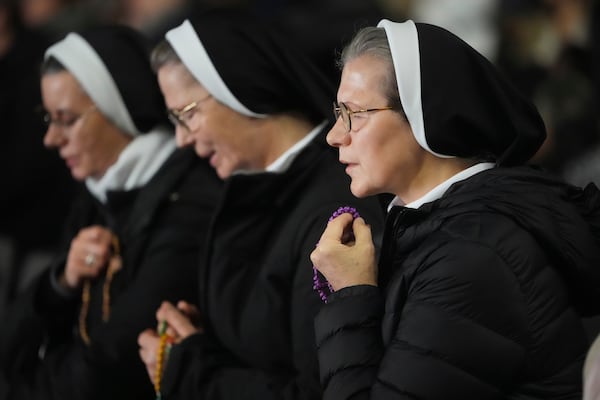 Nuns pray during a rosary prayer for Pope Francis' health in St. Peter's Square at the Vatican, Tuesday, March 4, 2025. (AP Photo/Alessandra Tarantino)