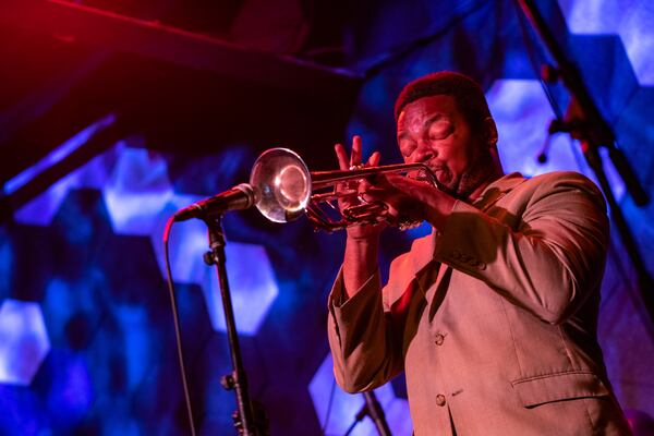 Terence Harper performs at the Wednesday jam at Venkman's. His parents were the house band at Churchill Grounds before it closed.  (Jenni Girtman for The Atlanta Journal-Constitution)