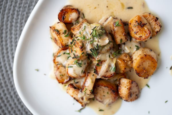 Chef Issa Prescott says he thinks lemongrass doesn't get the attention it deserves. Here, it plays a role in King Trumpet Mushroom Scallops with Lemongrass Bechamel. (Ryan Fleisher for The Atlanta Journal-Constitution)