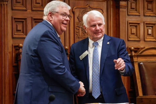 From left, House Appropriations Chairman Matt Hatchett shakes hands and takes a photo with Georgia Speaker of the House Jon Burns after members voted to approve the 2026 budget at the Georgia State Capitol on Tuesday, March 11, 2025 in Atlanta. (Natrice Miller/Atlanta Journal-Constitution via AP)