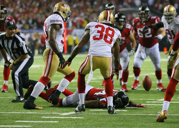 Falcons wide receiver Roddy White hits the turf after not being able to hold on to the pass on 4th and 4 in the final minutes, as the San Francisco 49ers held on to win the NFC Championship Game 28-24 at the Georgia Dome.