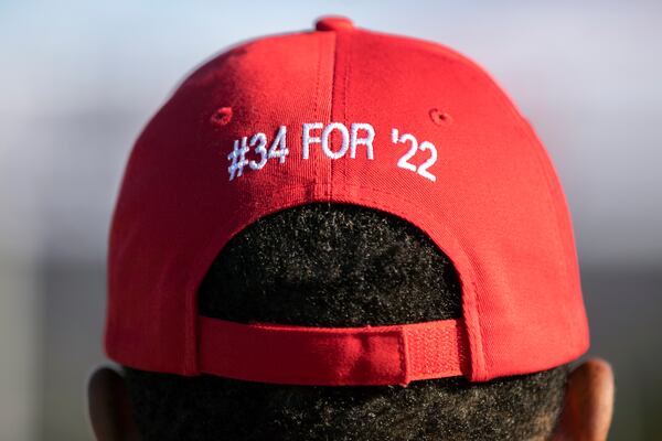 A supporter for Georgia Republican Senate candidate Herschel Walker waits for the Unite Georgia Bus Stop Tour to start, Saturday, Oct. 15, 2022, in Savannah. The cap's #34 refers to Walker's retired jersey number from his football days at the University of Georgia. (Photo: Stephen B. Morton for The Atlanta Journal-Constitution)