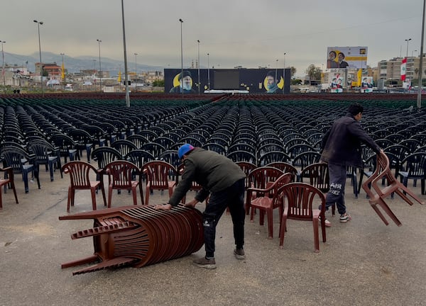 Workers set chairs outside Beirut's City Sportive stadium, a day ahead of the funeral procession of Hezbollah leaders Sayyed Hassan Nasrallah and Sayyed Hashem Safieddine, in Beirut, Lebanon, Saturday, Feb. 22, 2025. (AP Photo/Hussein Malla)