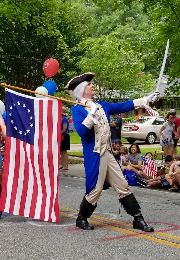 A George Washington impersonator in the Avondale parade carries a flag now deemed offensive to at least one former NFL quarterback. Photo courtesy of Jim Glenister