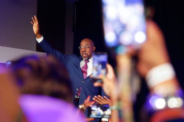 U.S. Sen. Raphael Warnock waves at supporters after winning the senate runoff election on Dec. 6, 2022. (Natrice Miller/AJC)  