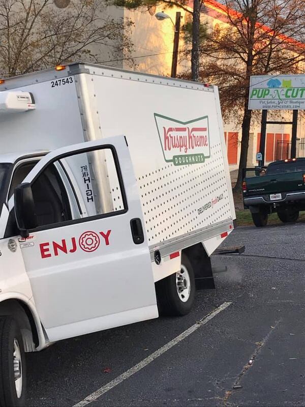 A Krispy Kreme delivery truck spilled dozens of doughnuts onto Peachtree Road.