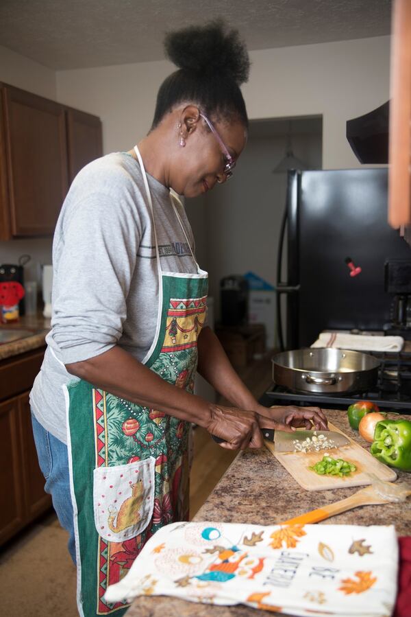 Jamilah Najeeullah starts food prep in advance of Thanksgiving Day. This is her first Thanksgiving meal in her new Atlanta Habitat home. CONTRIBUTED BY TOSH BYRD