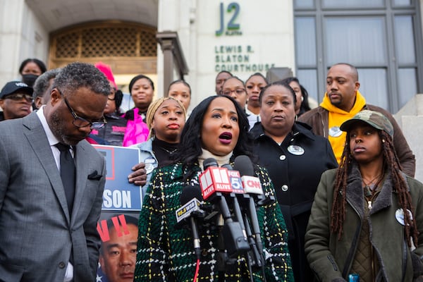 Attorney Tanya Miller, center, speaks during a press conference Monday in Atlanta regarding the most recent development in the case of Jimmy Atchison, who was shot by an Atlanta police officer in 2019. CHRISTINA MATACOTTA FOR THE ATLANTA JOURNAL-CONSTITUTION