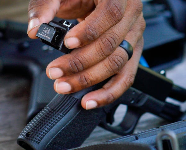 A switch or conversion device placed on a handgun's trigger as part of an ATF demonstration. The device changes the gun into a fully automatic handgun. Friday, July 28th, 2023 (Ben Hendren for The Atlanta Journal-Constitution)