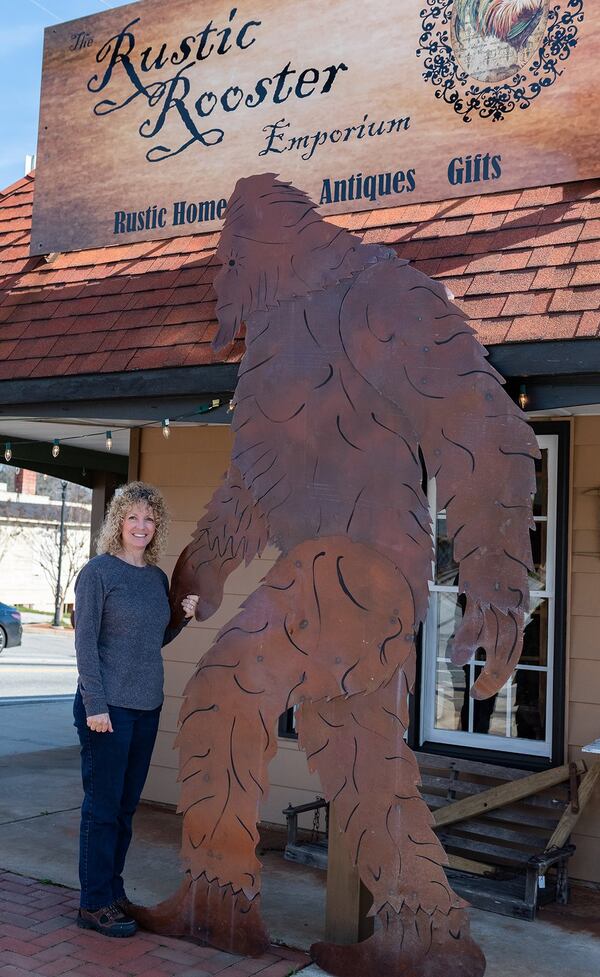 Marianne Quigg bonds with one of two “Sasquatches” on the Cleveland square. Contributed by E. Lane Gresham