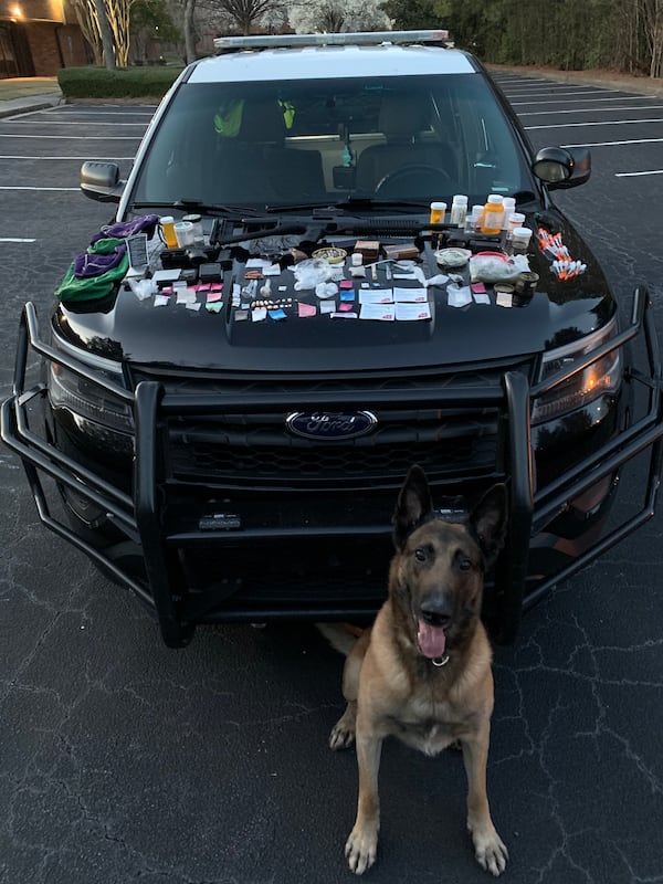 Marietta police discovered more than 100 pills and drugs such as heroin, fentanyl, crack cocaine and ketamine during a traffic stop Sunday on Franklin Gateway. K-9 Atos assisted with the drug bust.