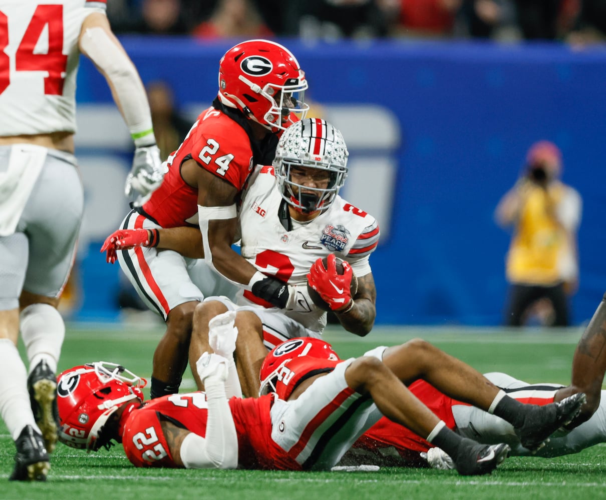 Ohio State Buckeyes wide receiver Emeka Egbuka (2) completes a 19 yard pass from quarterback C.J. Stroud (7) during the second quarter of the College Football Playoff Semifinal between the Georgia Bulldogs and the Ohio State Buckeyes at the Chick-fil-A Peach Bowl In Atlanta on Saturday, Dec. 31, 2022. (Jason Getz / Jason.Getz@ajc.com)