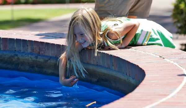 Sept. 6, 2010: Sadie Estes, 4, of Marietta, cools off in the Marietta Square fountain during the 24th Annual Art in the Park festival.