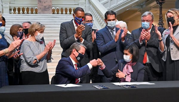 Georgia Gov. Brian Kemp and Centers for Medicare and Medicaid Services Administrator Seema Verma celebrate with a fist bump after Verma announced the Trump administration's approval of Kemp's health care "waiver" on Thursday, Oct. 15, 2020. (Hyosub Shin/The Atlanta Journal-Constitution/TNS)