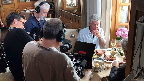 In this photo taken on Monday, June 4, 2018, Anthony Bourdain is seen with a film crew at Wistub de la Petite Venise, a restaurant in Colmar, France. Anthony Bourdain, the celebrity chef and citizen of the world who inspired millions to share his delight in food and the bonds it created, was found dead in his hotel room Friday, June 8 in France while working on his CNN series on culinary traditions. He was 61.