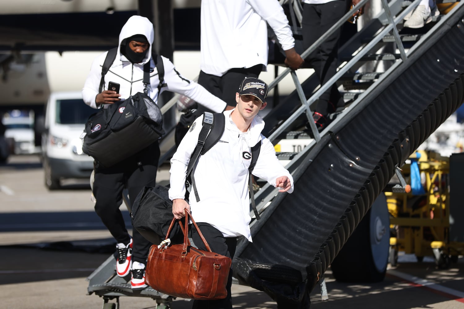 Georgia quarterback Stetson Bennett leaves the plane as the Bulldogs arrived at Hartsfield-Jackson Atlanta International Airport after their 33-18 win against the Alabama Crimson Tide at the 2022 College Football Playoff National Championship. Tuesday, January 11, 2022. Miguel Martinez for The Atlanta Journal-Constitution