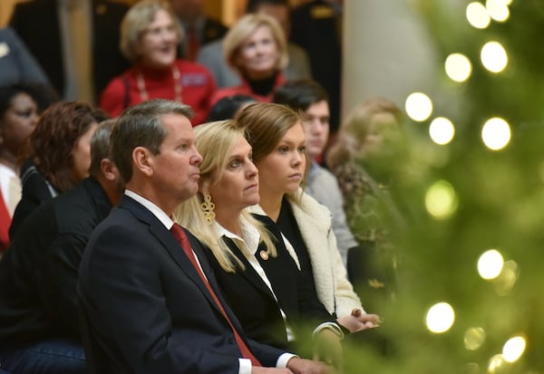 Gov. Brian Kemp sits with first lady Marty Kemp and youngest daughter Amy Porter during the annual State Capitol Tree Lighting Ceremony with a 25-foot Eastern Red Cedar from Cobb County at the Georgia Capitol on Dec. 3, 2019. (Hyosub Shin / Hyosub.Shin@ajc.com)