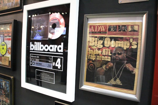 Framed recording plaques and news clippings related to Big Oomp's career hang from the dining room walls inside BOSK.