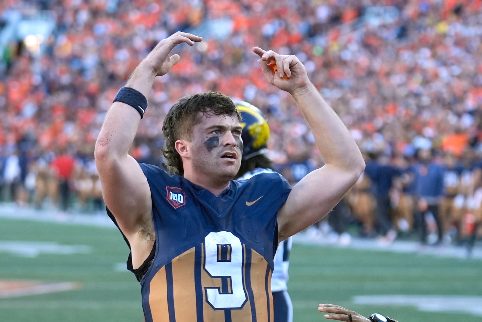 Illinois quarterback Luke Altmyer celebrates his touchdown during the second half of an NCAA college football game against Michigan on Saturday, Oct. 19, 2024, in Champaign, Ill. (AP Photo/Charles Rex Arbogast)