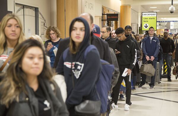 Multiple security lines at Hartsfield-Jackson International Airport snaked through baggage claim then the atrium in both domestic terminals on Monday February 4th, 2019. Official expected over 100,00 travelers to pass through the airport today. (Photo by Phil Skinner)