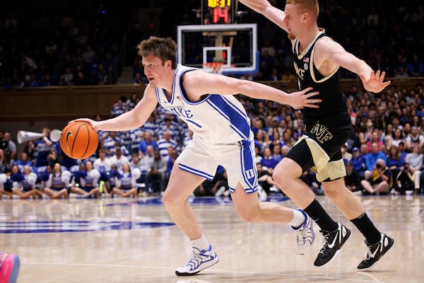 Duke's Kon Knueppel, left, handles the ball ahead of Wake Forest's Cameron Hildreth, right, during the second half of an NCAA college basketball game in Durham, N.C., Monday, March 3, 2025. (AP Photo/Ben McKeown)