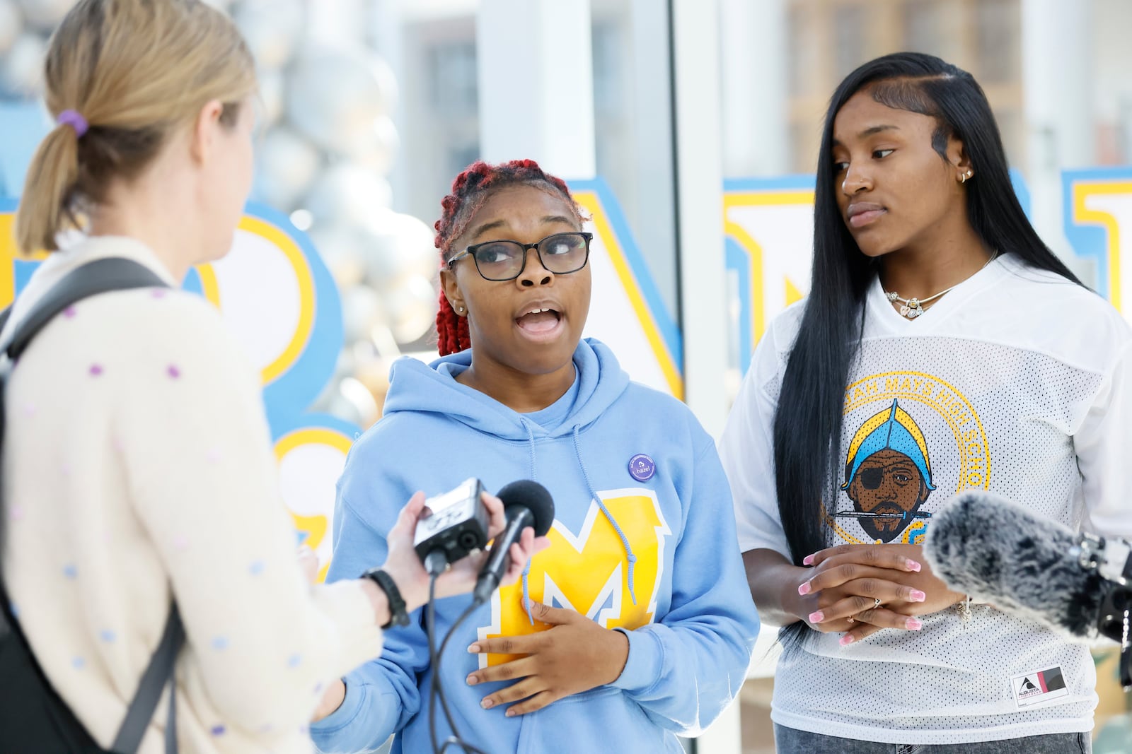 Benjamin E. Mays High School seniors Tamar Echols, 18, center and Madison Allen, 18, right, discuss Wednesday's shooting at the school. The students stressed Mays is a good school and don't want the incident to negatively impact its reputation.
(Miguel Martinez /miguel.martinezjimenez@ajc.com)