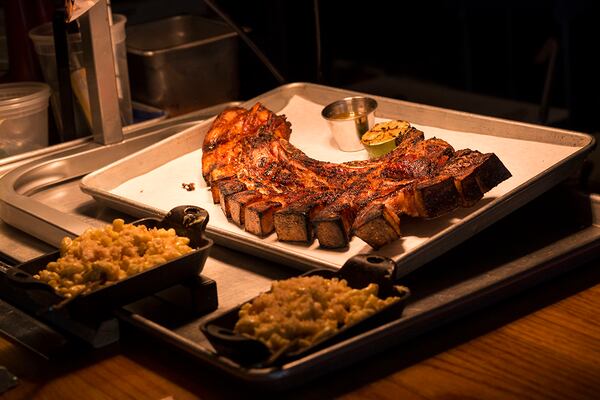 The "Puerto Rican Fried Pork Chop" is featured on the Porch Light Latin Kitchen lunch menu. The meal consists of a Loin Chop with ribs, belly, and skin with citrus mojo. (Chad Rhym/ Chad.Rhym@ajc.com)