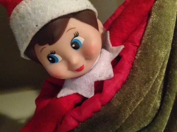 Hiding in plain sight helps an "Elf on the Shelf" do her job. Here she is, waiting patiently to be discovered by a child who isn’t bothering to look for her. NEDRA RHONE / NRHONE@AJC.COM