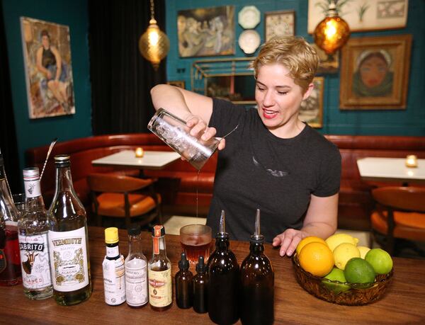 Kathryn DiMenichi, co-owner of Cardinal and Third Street Goods, mixes up a Common Tiger cocktail, a new addition to the fall drink menu. Curtis Compton/ccompton@ajc.com