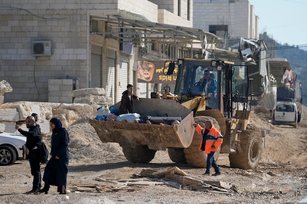 Residents of the West Bank urban refugee camp of Nur Shams evacuate their homes and carry their belongings as the Israeli military continues its operation in the area on Wednesday, Feb. 26, 2025. (AP Photo/Majdi Mohammed)