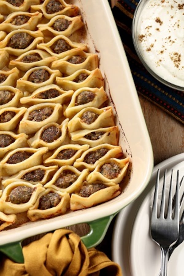 The filled and formed manti dumplings are packed together in a buttered baking dish, then baked until golden brown. Serve with a garlic-laced yogurt sauce. (Michael Tercha/Chicago Tribune/TNS)