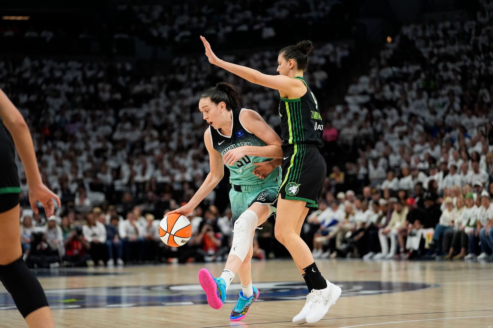 New York Liberty forward Breanna Stewart drives to the basket against Minnesota Lynx forward Cecilia Zandalasini (9) during the first half of Game 4 of a WNBA basketball final playoff series, Friday, Oct. 18, 2024, in Minneapolis. (AP Photo/Abbie Parr)