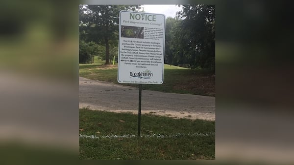 The City of Brookhaven has put up a sign and drawn a chalk line through Brookhaven Park to show which side is owned by the city and which side is owned by DeKalb County.