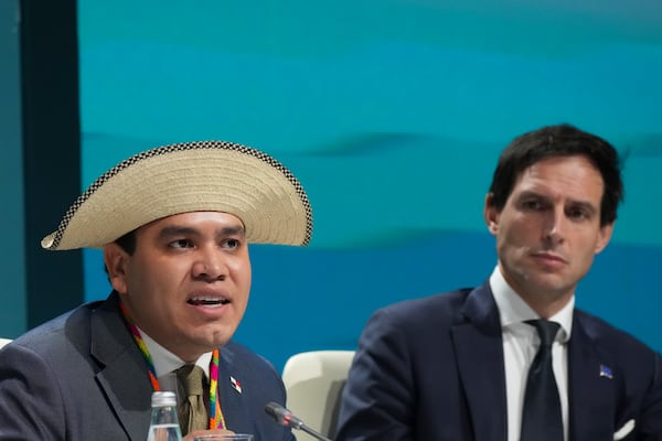 Panama Climate Envoy Juan Carlos Monterrey Gomez, left, and Wopke Hoekstra, EU climate commissioner, attend a session on climate targets during the COP29 U.N. Climate Summit, Thursday, Nov. 21, 2024, in Baku, Azerbaijan. (AP Photo/Sergei Grits)