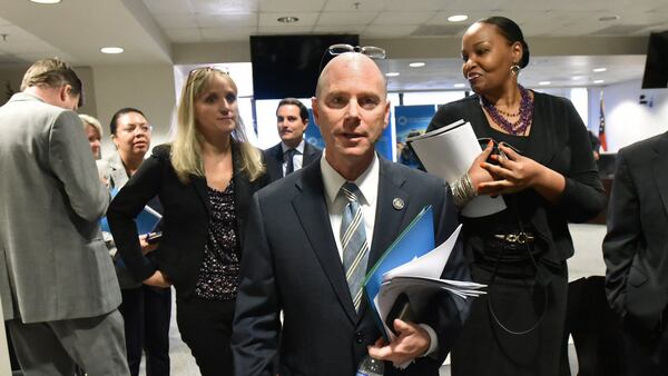 Frank W. Berry, center, Commissioner of Georgia Department of Community Health (DCH), leaves after a board meeting in Atlanta on Aug. 8. The AJC asked to meet with Berry and others at DCH to discuss cases of abuse, neglect and deaths uncoverered by the newspaper’s investigation. Berry  would only answer questions in writing. Asked to comment on the deaths and injuries, Berry wrote that “The health and wellbeing of Georgians is always our top priority.” (Hyosub Shin / Hyosub.Shin@ajc.com)