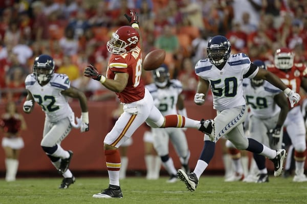 Kansas City Chiefs tight end Tony Moeaki (81) misses a pass as he is chased by a group of Seattle Seahawks defenders during the first half of an NFL preseason football game Friday, Aug. 24, 2012, in Kansas City, Mo. (AP Photo/Charlie Riedel)