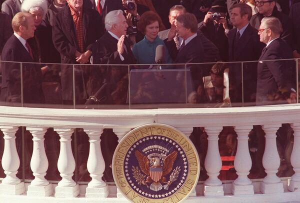 Jimmy Carter takes the oath of office, as his wife, Rosalynn, holds the family bible, during the inauguration ceremony in January of 1977. Administrating the oath is Chief Justice of the U.S. Warren Burger. Looking on, from left, are: outgoing President Gerald Ford, and at right, Vice President Walter Mondale, and former Vice President Nelson Rockefeller. (Associated Press)