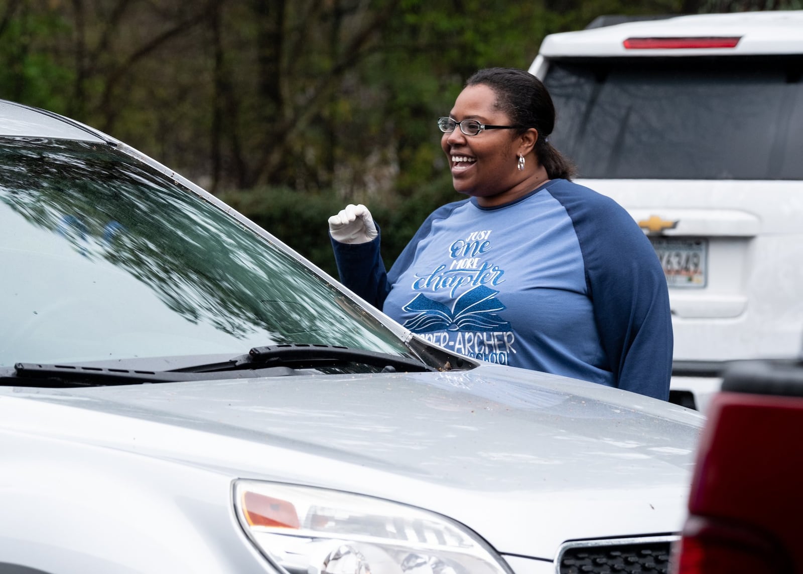 Harper-Archer Elementary School Principal Dione Simon Taylor talks with a parent and student who came to the school on March 24, 2020 to pick up a device so they could continue studying during the coronavirus pandemic. Ben@BenGray.com for the Atlanta Journal-Constitution