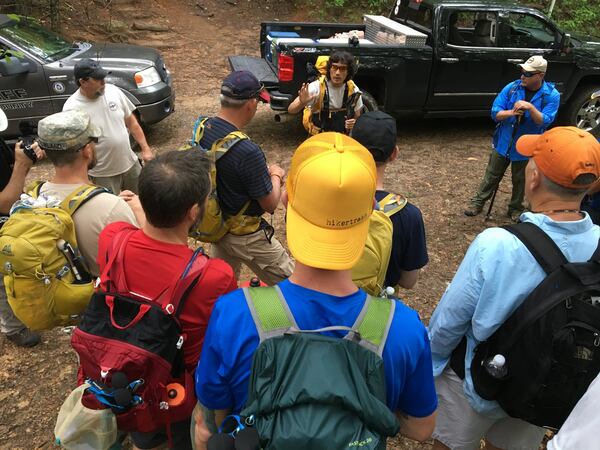 Steve Baskis (center) talks to a group of blinded veterans and their guides June 1 at Blue Ridge Gap about the importance of communication while hiking the Appalachian Trail. Baskis, an Army veteran, lost his sight while serving in Iraq. CONTRIBUTED BY FRANK REDDY