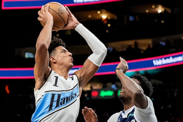 Atlanta Hawks forward Jalen Johnson (1) shoots against Dallas Mavericks forward Olivier-Maxence Prosper (8) during the first half of an NBA basketball game, Monday, Nov. 25, 2024, in Atlanta. (AP Photo/Mike Stewart)