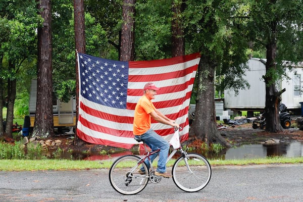 George Smith, 67, from Homerville, is seen riding in front of an American flag in front of his trailer home in Homersville, Georgia, on Tuesday, August 6, 2024. “Luckily, Nothing big happened around here; just a few trees down,” Smith said.
(Miguel Martinez / AJC)