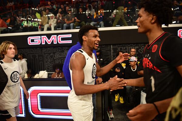 Bronny James (left) of the California Basketball Club shakes hands with Amen Thompson of the City Reapers after a preseason game. (Photo by Kyle Hess/Overtime Elite)