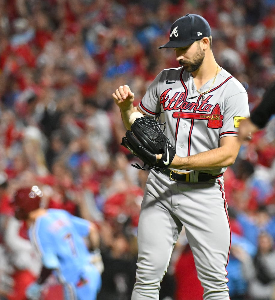 Atlanta Braves starting pitcher Spencer Strider (99) waits as Philadelphia Phillies’ Trea Turner (7) rounds the bases behind him after a solo home run during the fifth inning of NLDS Game 4 at Citizens Bank Park in Philadelphia on Thursday, Oct. 12, 2023.   (Hyosub Shin / Hyosub.Shin@ajc.com)