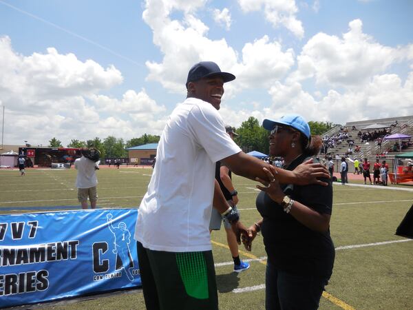 Cam Newton and his mom Jackie Newton kid around on the field of his alma mater, Westlake High School. Photo: Jennifer Brett