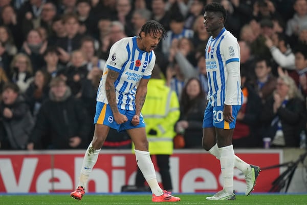 Brighton's Joao Pedro, left, celebrates after scoring during the English Premier League soccer match between Brighton and Manchester City at Falmer Stadium in Brighton, England, Saturday, Nov. 9, 2024. (AP Photo/Alastair Grant)