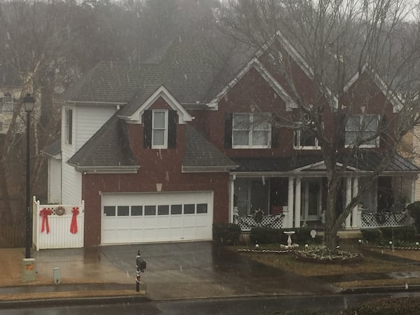 Snow fell in a Suwanee neighborhood around 10 a.m. Friday.