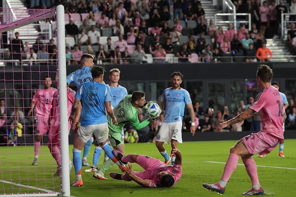 New York City FC goalkeeper Matt Freese (49) snags the ball as Inter Miami forward Luis Suarez hits the ground during the first half of an MLS soccer match, Saturday, Feb. 22, 2025, in Fort Lauderdale, Fla. (AP Photo/Rebecca Blackwell)