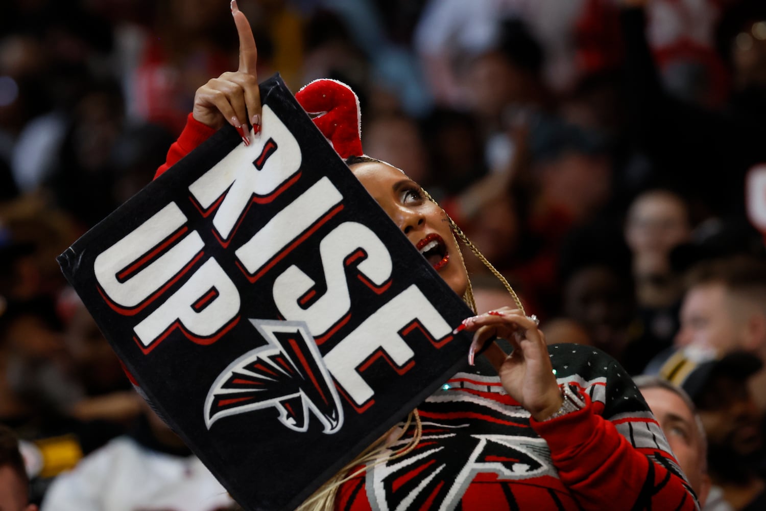 A Falcons fan cheers during a fourth-quarter break Sunday at Mercedes-Benz Stadium. (Miguel Martinez / miguel.martinezjimenez@ajc.com)