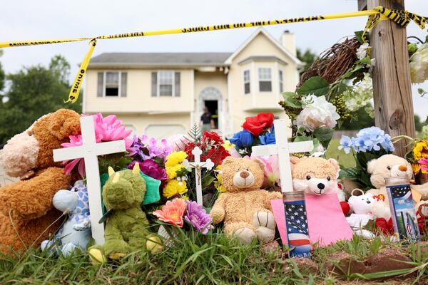 A memorial sits at the home where three children died on Woodwind Drive.